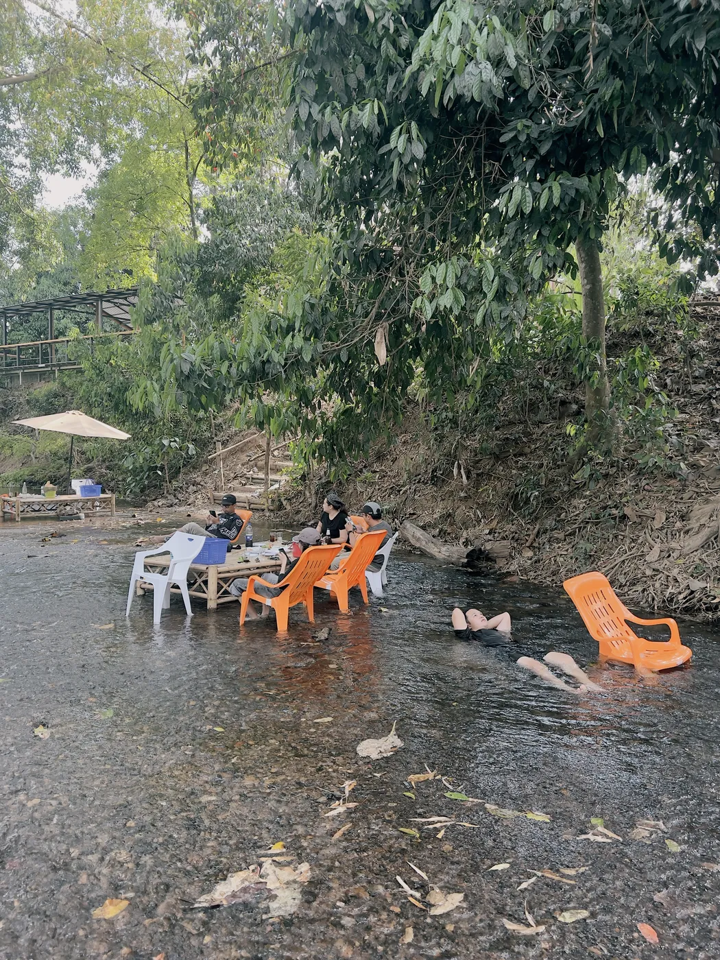 ลูกค้านั่งพักในลำธารตื้นกลางธรรมชาติ
